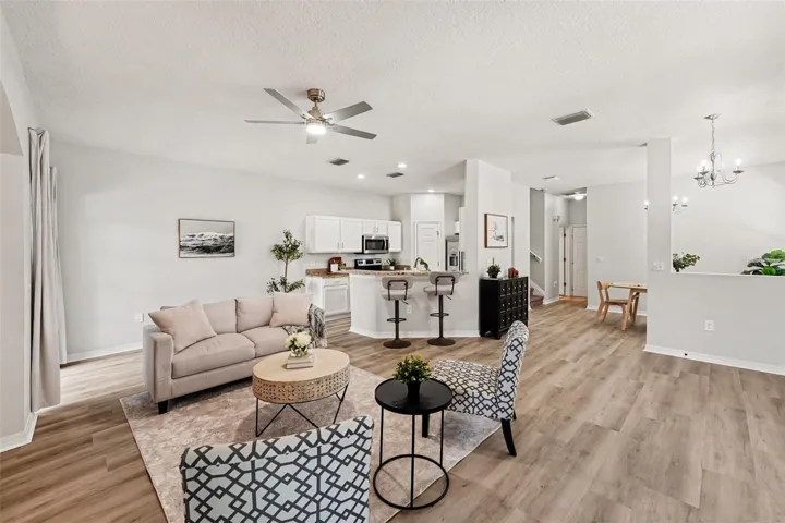 Living room view, with LVP floors and spacious eat-in kitchen