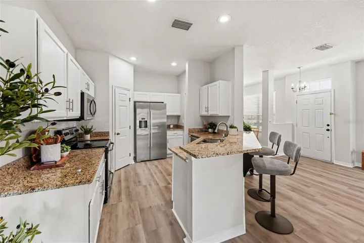 Spacious kitchen with walk-in pantry and stainless steel appliances