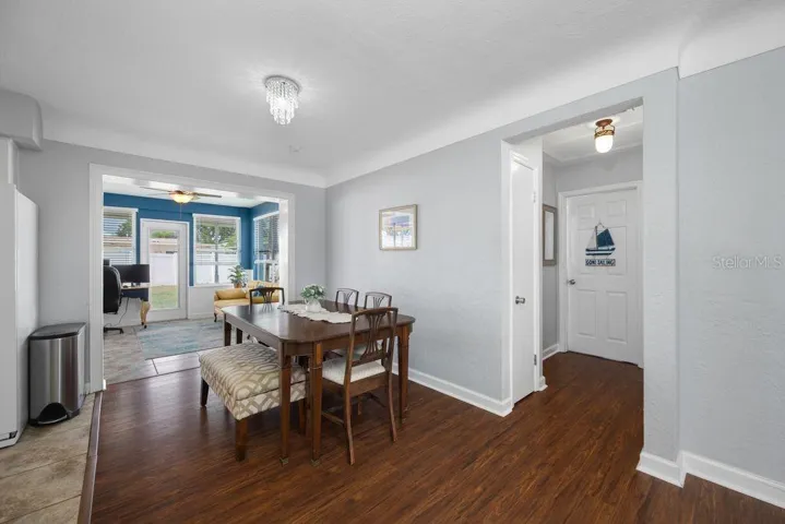 View of Dining Room - Kitchen to the Left, Florida Room Straight Ahead, Hallway to the Right
