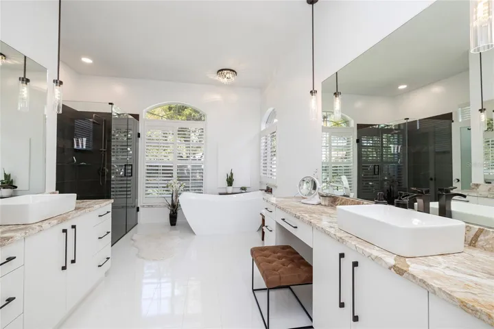 Updated primary bath with beautiful walk in shower and stand alone tub