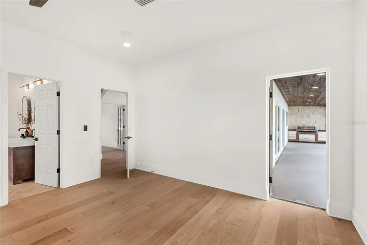 PRIMARY BEDROOM LEADING OUT TO THE POOL AREA.