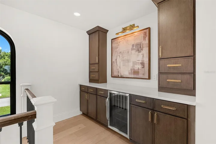 CUSTOM LOFT RETREAT WITH BUILT-IN STORAGE AND BEVERAGE FRIDGE