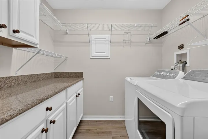 The laundry room offers nice counter space as well as storage!