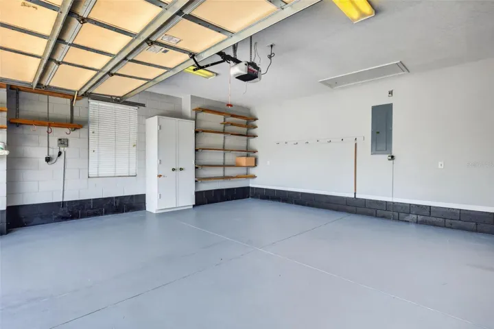 Painted garage floors and shelving adds to functionality.