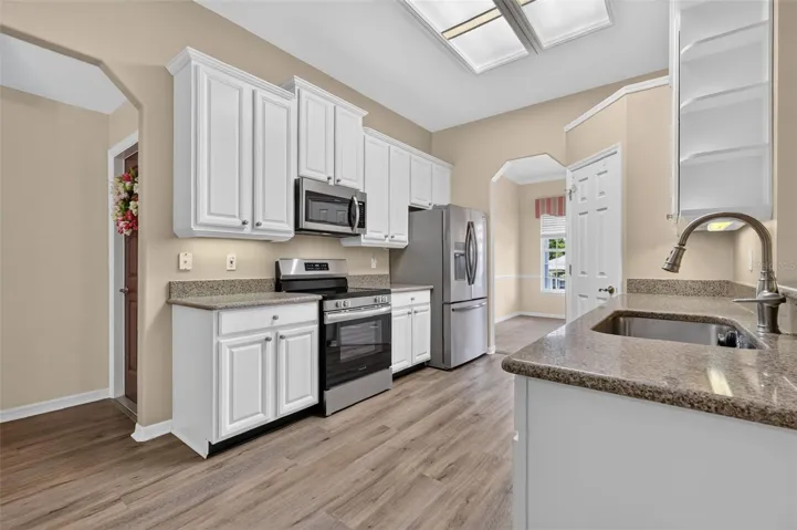 Updated kitchen w/ quartz countertops, stainless appliances, and bright white cabinets.