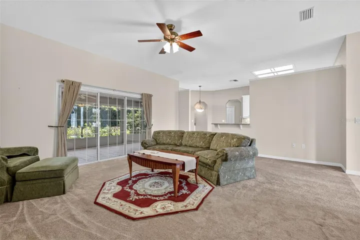 Sliders from family room lead out to the screen-enclosed lanai.