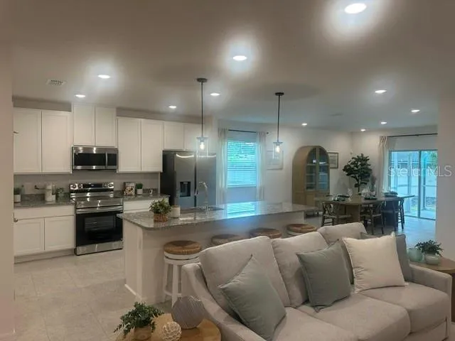 Kitchen with stainless steel appliances, and large island
