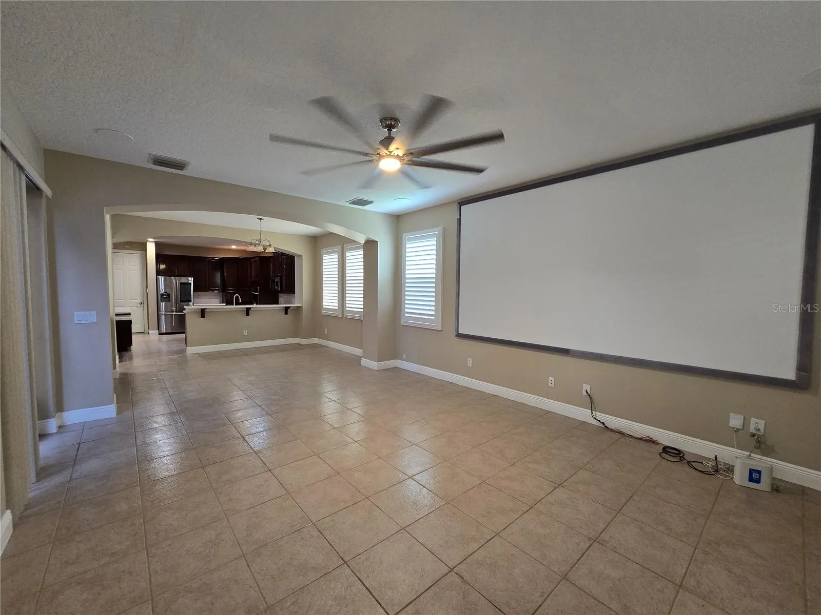 View from great room towards dining/breakfast space and kitchen. Architectural features and plantation shutters.