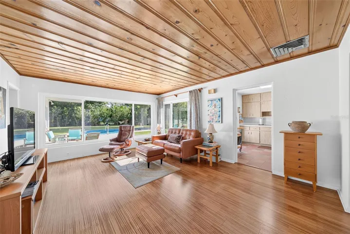 Living room with original pine paneled ceiling