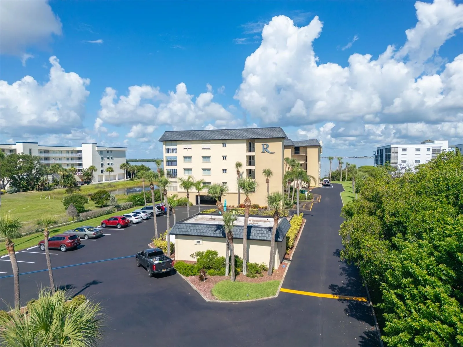 Riverwest condominium building exterior with resident parking — 190 Escambia Lane, Cocoa Beach, FL