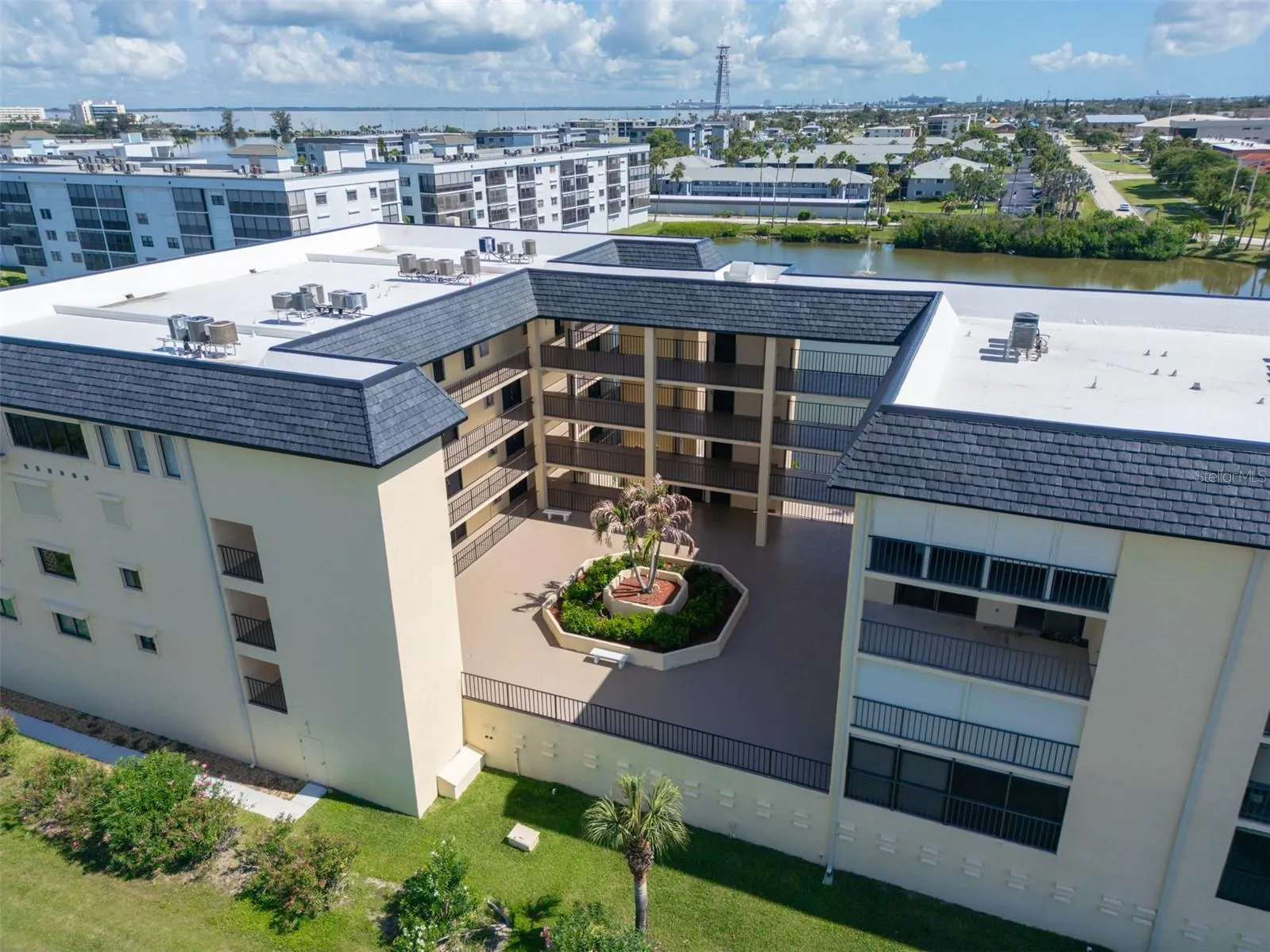 Interior courtyard at Riverwest condo with covered walkways and palm tree garden, Cocoa Beach, Florida
