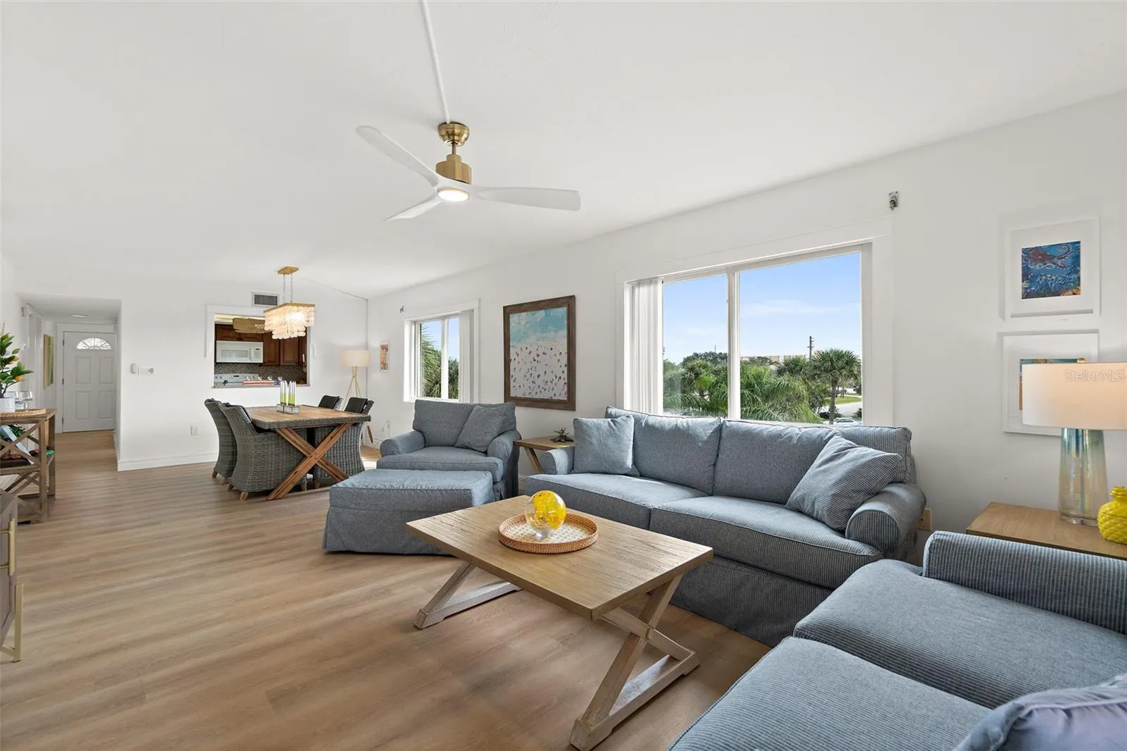 Living room with picture windows overlooking Riverwest grounds, view toward Atlantic Ocean, Cocoa Beach