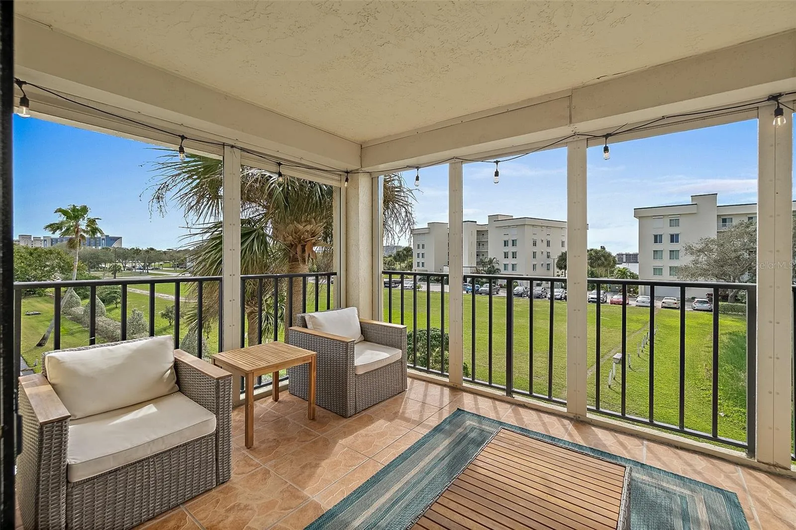 Balcony with seating area and direct pond view, Riverwest condo, Cocoa Beach, Florida