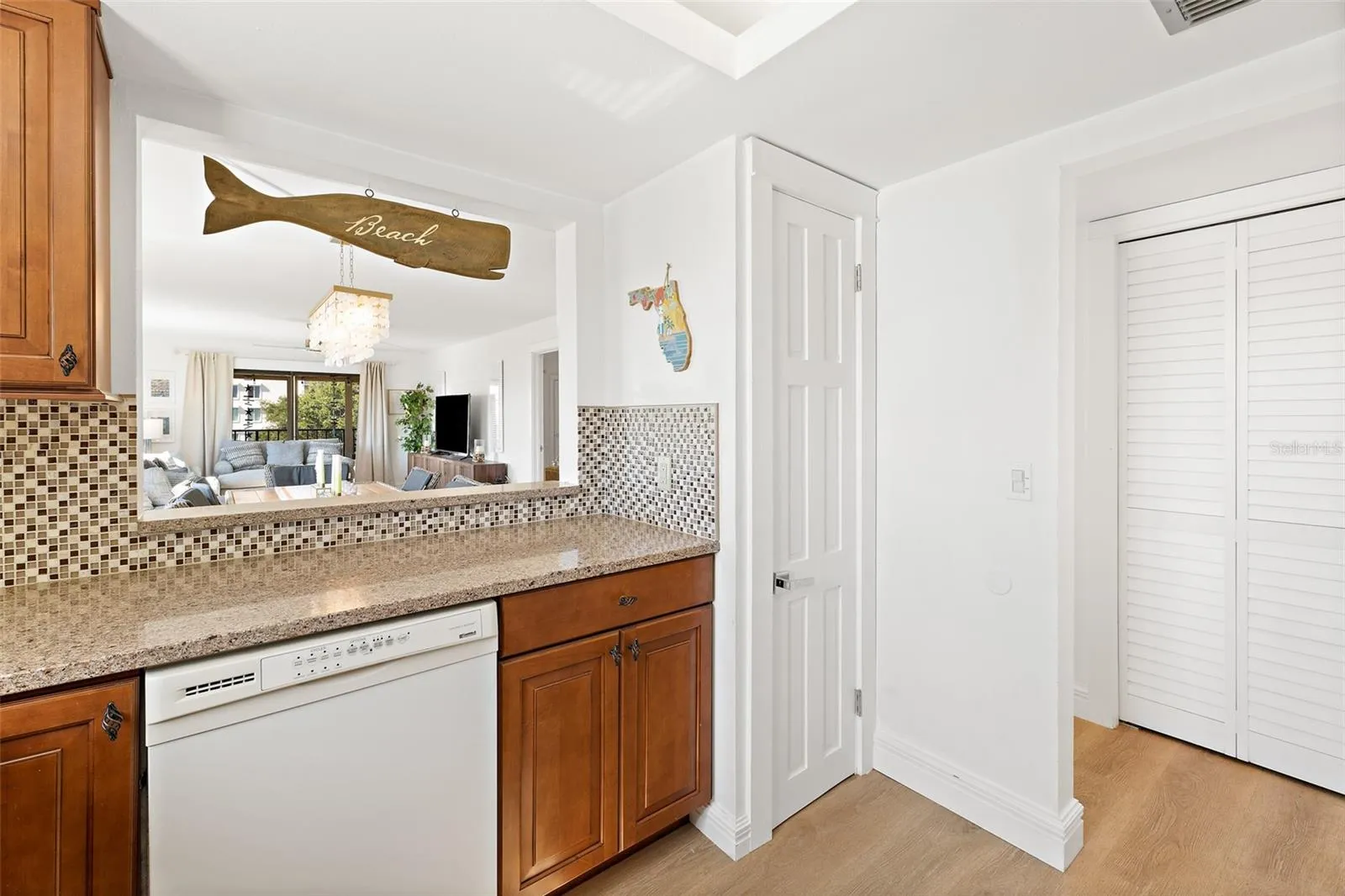 Kitchen pass-through with dishwasher and pantry closet, Cocoa Beach condo