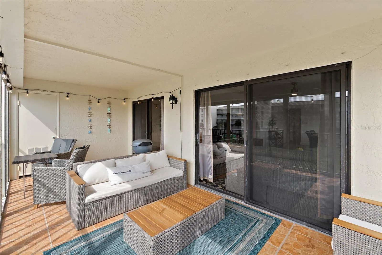 Balcony seating area with sliding glass door access, Riverwest condo, Cocoa Beach