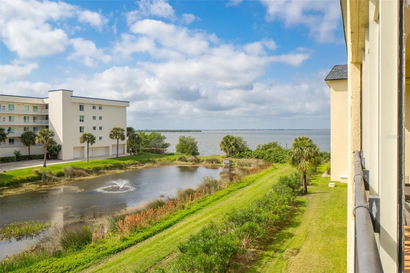 Aerial river-facing view from Riverwest condo balcony showing pond and Banana River, Cocoa Beach, Florida