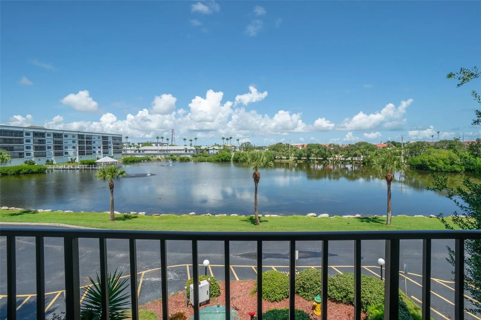 Front walkway view of pond, fountain from 3rd-floor Riverwest condo, Cocoa Beach, Florida