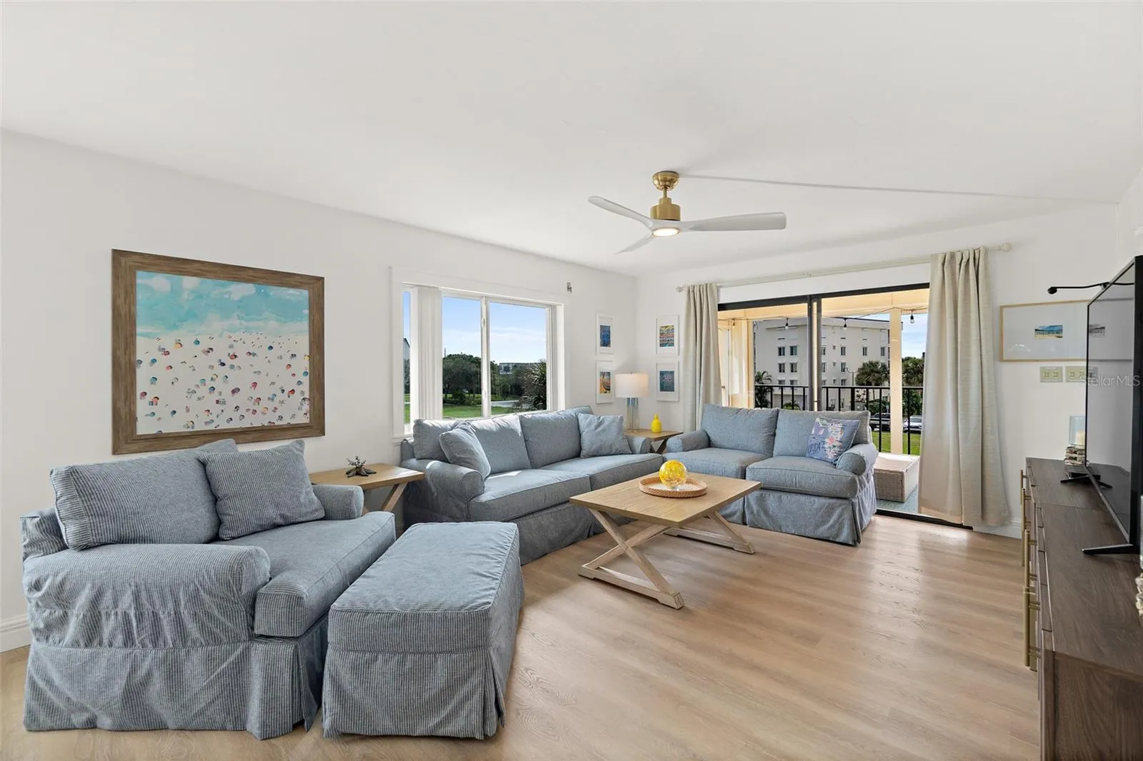 Living room with sliding glass doors to balcony, direct pond view, Riverwest, Cocoa Beach