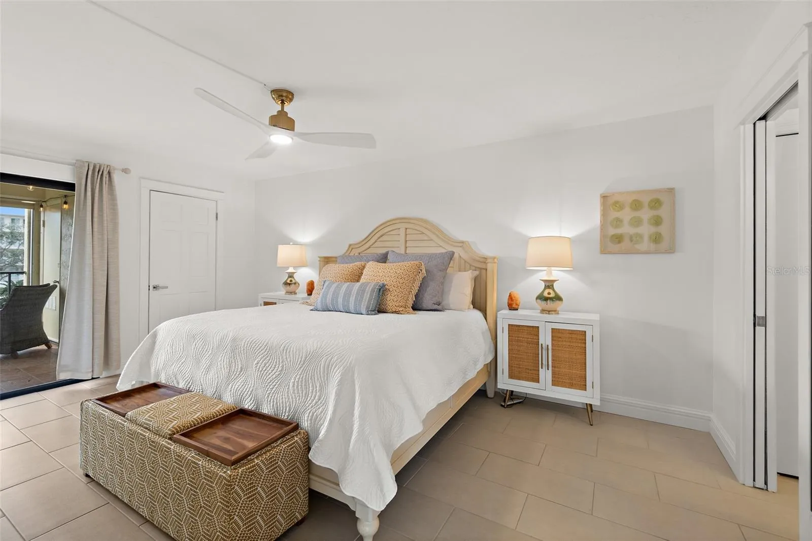 Primary bedroom with private balcony access and pond view, Riverwest condo, Cocoa Beach