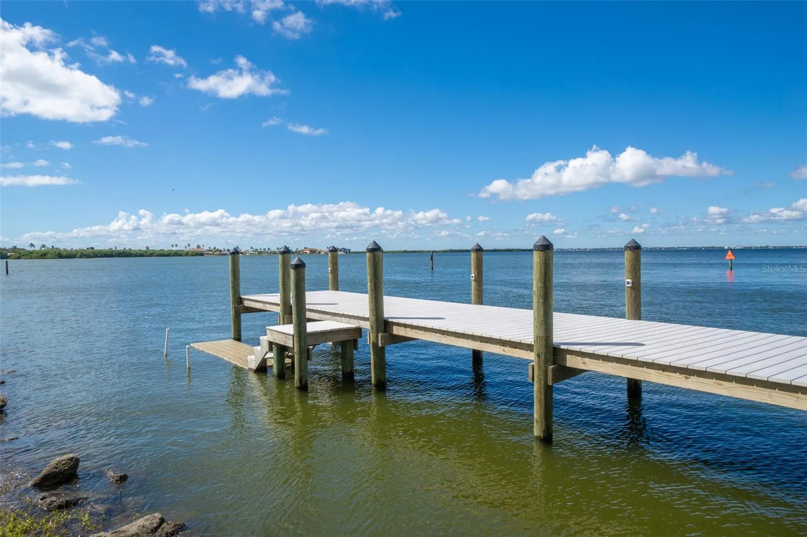 Private dock with steps and pilings on the Banana River, Riverwest, Cocoa Beach