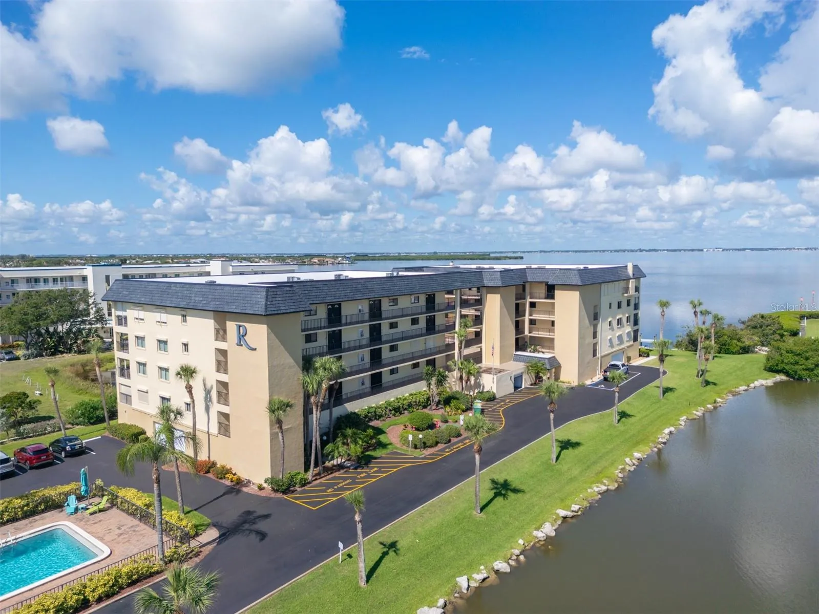 Riverwest condo building with Banana River views and lush tropical landscaping — Cocoa Beach, Florida