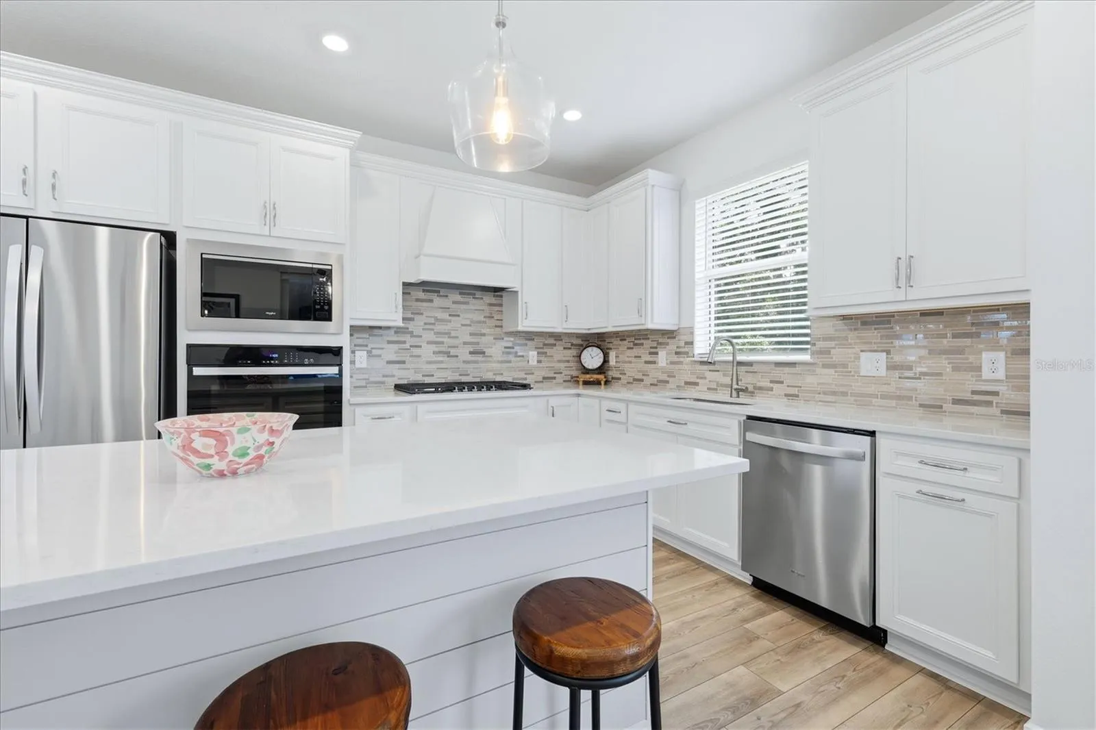 Chef's kitchen with stovetop, wall oven and microwave layout