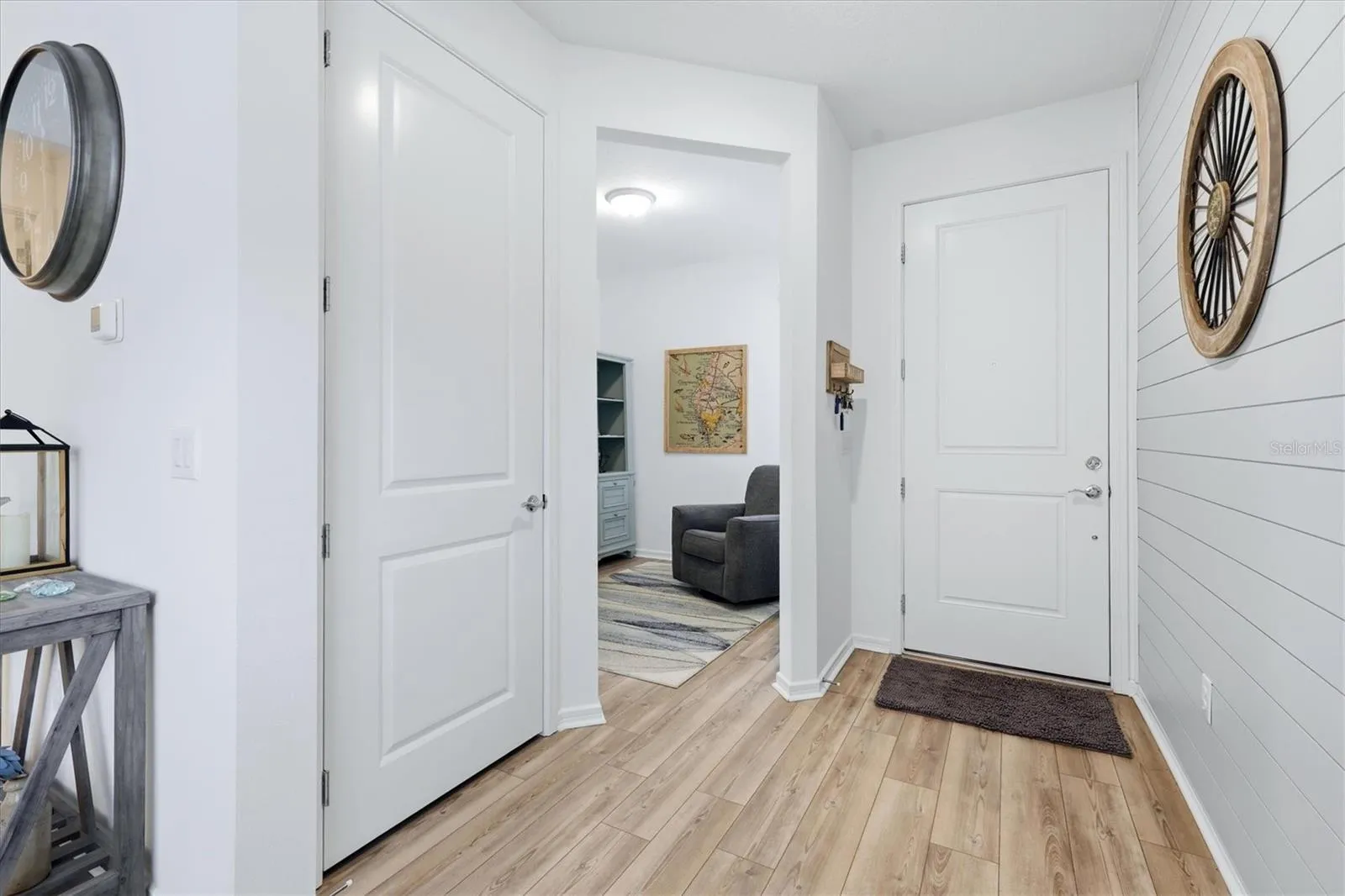 Foyer features a shiplap accent wall and a closet