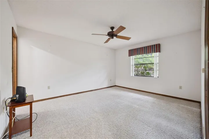 Second bedroom with walk-in closet and newly installed carpet