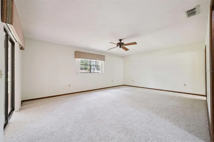 Primary bedroom with newly installed carpet, a large walk-in closet and en suite bath