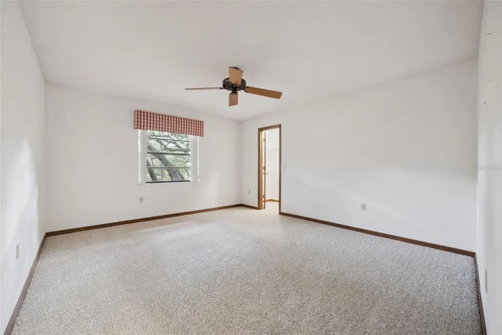 Third bedroom with newly installed carpet and a walk-in closet.