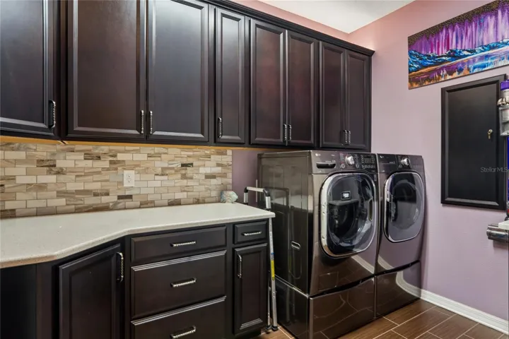 Gorgeous Backsplash and Custom Cabinetry Make Laundry More Enjoyable