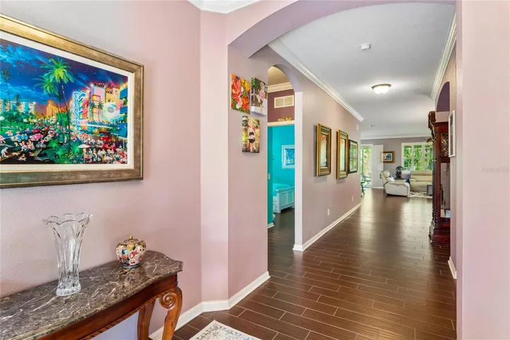 The Wide Hallway Gives Way to the Open Living Space and Kitchen Area