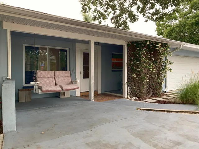 Front with two person hanging swing and a little private bistro seating area behind the Bleeding Heart vine. This home also has parking for 7-8 vehicles and any recreational toys you might be bringing with you, like a boat, jetskis, trailer, etc. The back yard has double gates where you can park things too.