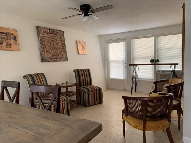 Cozy conversational seating in the Florida room. Door goes out to the fenced back yard (6 foot fence with double gates). There is another large table and 4 chairs out on the patio.