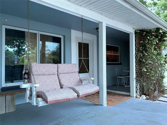 Enjoy coffee and cocktails on the swing or in the private little alcove. The big picture window goes to the main family room, and the smaller window to the right of the front door goes into the kitchen. There is also a screened storm door on the front door so you can open up the house to the breezes when the weather is nice.