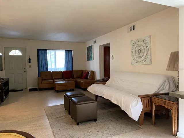 Main living area with sectional leather sofa and full size pullout futon.