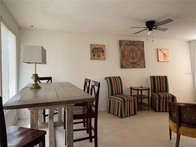 Additional bar height dining, workspace with four solid wood chairs.