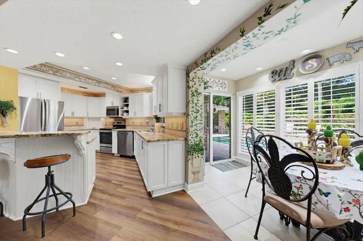 Kitchen with eat-in space leading to pool area