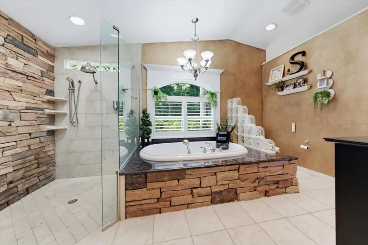 Primary bathroom with stone finishes