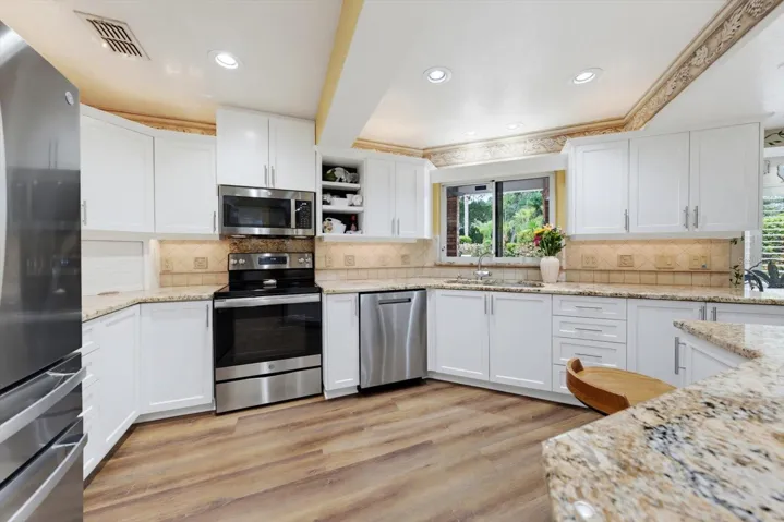 Kitchen with granite counter tops and stainless appliances