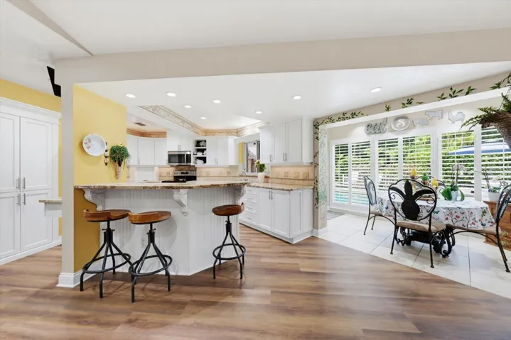 Kitchen with bar seating and separate eat-in area