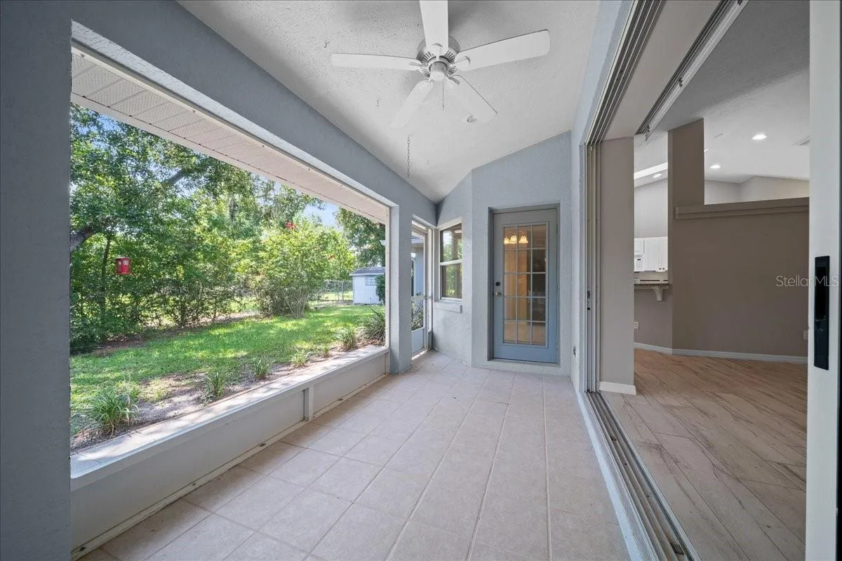 Screened in lanai overlooking serene backyard