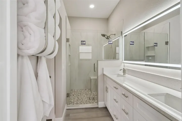 Primary ensuite with double vanities and walk-in shower