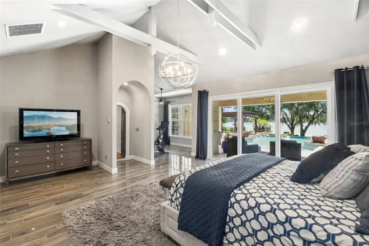 Spacious Primary Bdroom  with Flex room, vaulted ceilings with beams and of course a view of the Lake and the Pool!!!!