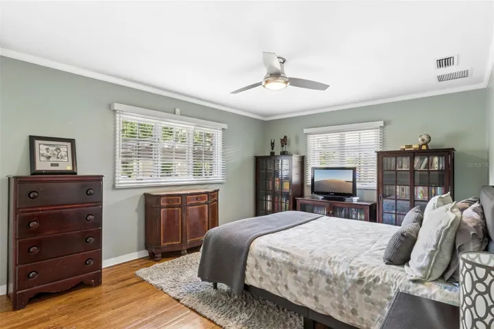 Bedroom #3 featuring customed closet and natural wood floors.
