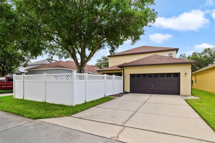 Outside, enjoy excellent CURB APPEAL, an attractive vinyl privacy fence and a rear-entry 2-CAR GARAGE with alley access, oversized workbench, and direct access to the lanai!