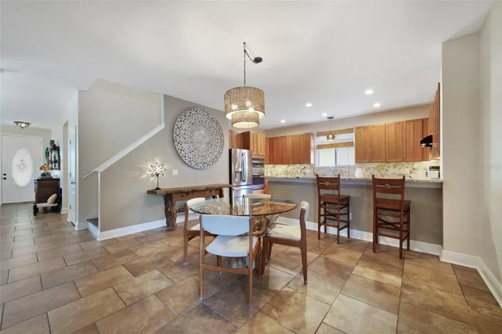 The kitchen is designed to be the heart of the home, featuring sleek granite countertops that continue into the backsplash, ample cabinet storage, breakfast bar seating, and UPDATED STAINLESS STEEL APPLIANCES (all replaced in 2020 except the dishwasher – including a built-in wall oven!).