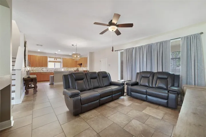 Family room is open to the kitchen with sliding glass doors that open to the screened lanai.