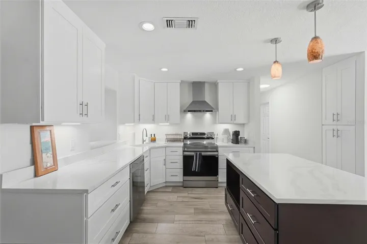 Stunning kitchen with shaker cabinets and a contrasting island.