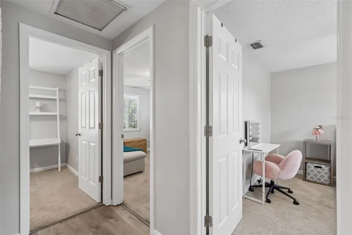 Hallway glimpses into the three beautiful bedrooms located on the northside of the home.